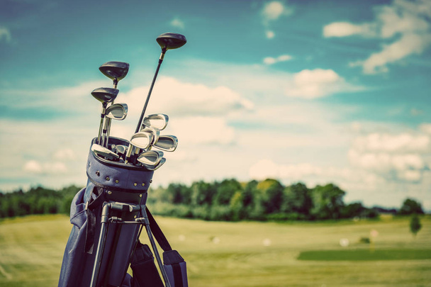 Golf equipment bag standing on a course. Summer sport and activity. Golf clubs close-up. - Photo, Image