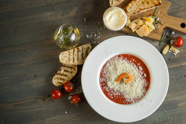 Dinner tomato cream soup on kitchen table with ingredients. Text area space for design menu or recipe - Foto, imagen