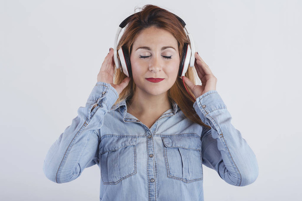 Happy young woman with headphones - 写真・画像