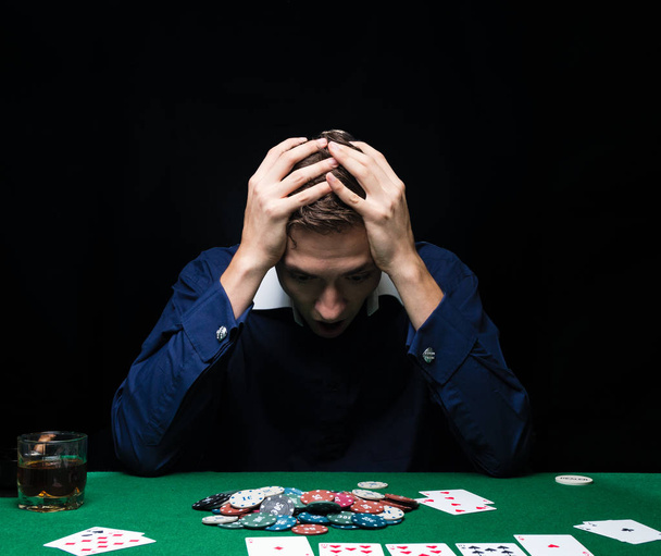 Man is playing poker. Emotional fail in game, game over for card - Photo, Image