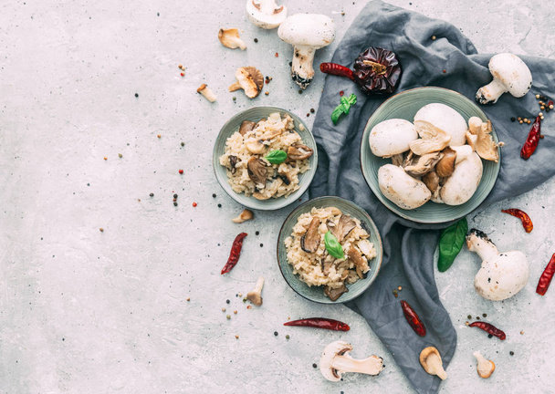Risotto with porcini mushrooms on wooden background. Flat lay composition - Photo, Image