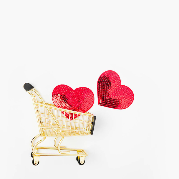 Closeup of heart signs in shopping cart isolated on white background - Photo, Image