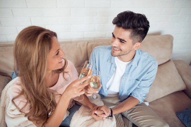 家でワインを飲む美しい若いカップル. - 写真・画像