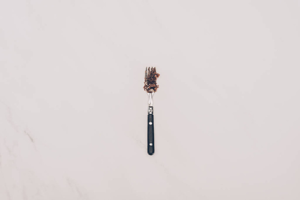top view of fork with cake pieces isolated on grey - Foto, Imagen