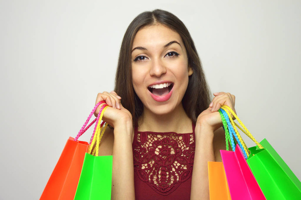 Wow face of an excited attractive woman with bags shopper in her hands - Photo, Image