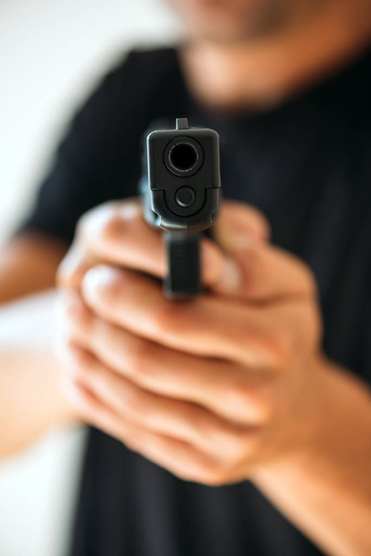 Men with handgun close up - Фото, изображение