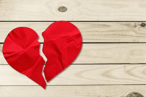 close-up of broken red heart on wooden background for Valentines Day  - 写真・画像