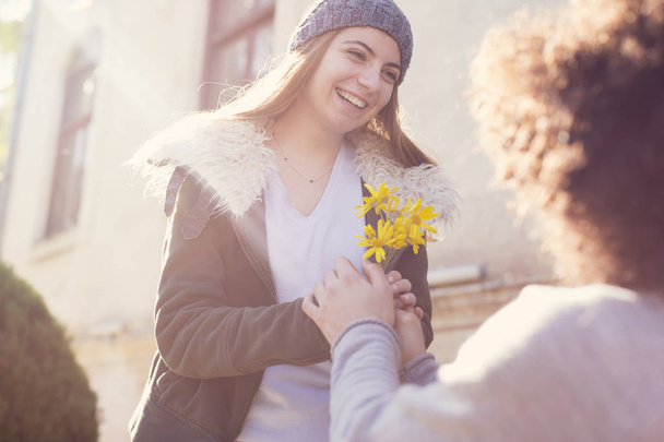 Young guy granting flower to his girlfriend in valentine day - Foto, Imagem