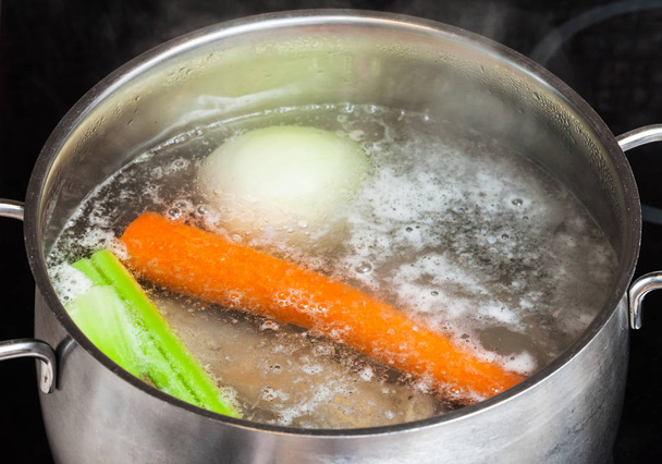 boiling meat broth in stew pan close up - Photo, Image