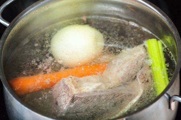 boiling beef broth in stew pan close up - Photo, Image