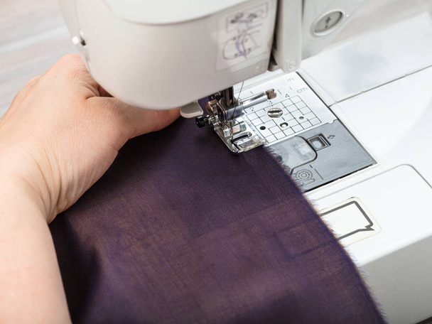 needlewoman sews strips of fabrics for patchwork - Φωτογραφία, εικόνα