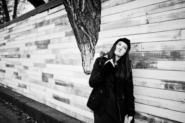 Young girl wear black headwear against wooden wall. - Foto, Imagem
