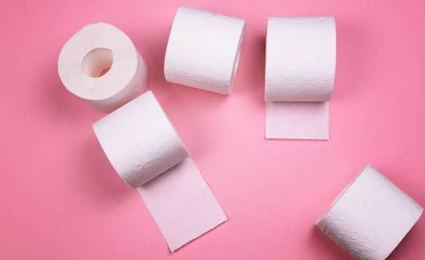 A few rolls of toilet paper on a bright colored background. - Fotografie, Obrázek