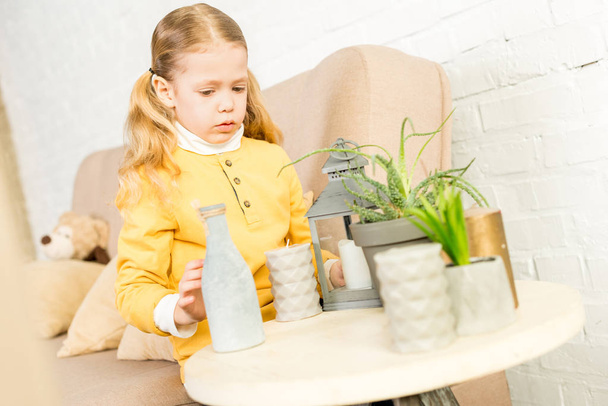 cute little child arranging objects on table during relocation - Photo, Image