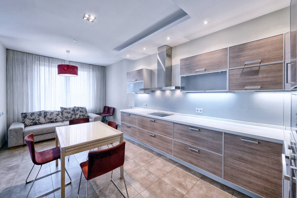 Modern design white kitchen in a spacious apartment. - Фото, зображення