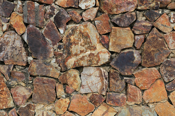 壁の背景の茶色の石の表面. - 写真・画像