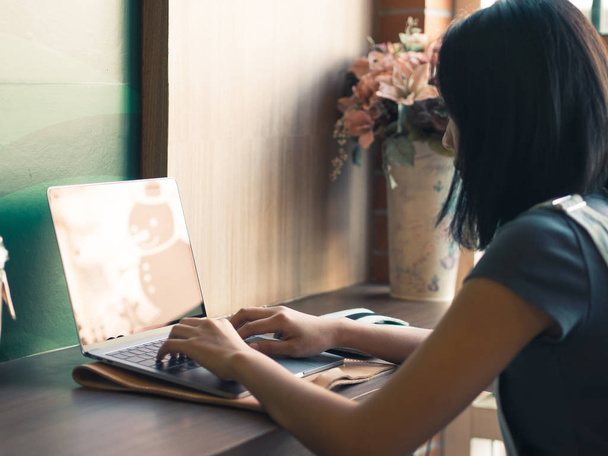 Woman is working on laptop in coffee cafe. - Фото, зображення