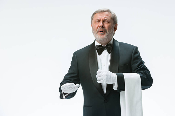 Senior waiter holding white towel - Fotó, kép