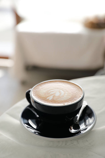 cappuccino or Latte art coffee made from milk on the wood table  - 写真・画像