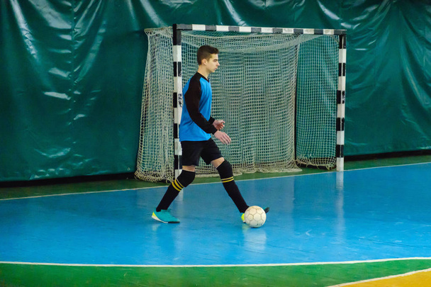 Goalkeeper catching a ball, mesh of the gate in mini football - Φωτογραφία, εικόνα