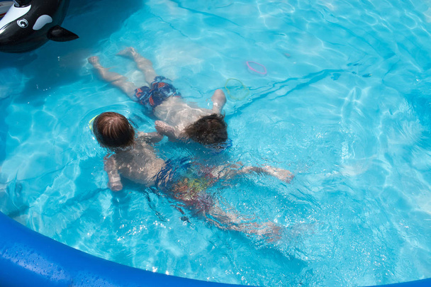 Young boys in swimming mask in swimming pool - Photo, Image