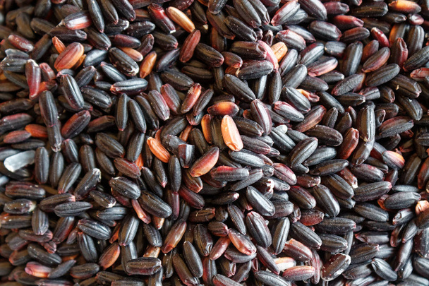 Texture of Coarse black rice The concept of proper nutrition and healthy lifestyle. Top view, close-up as background or texture - Photo, Image