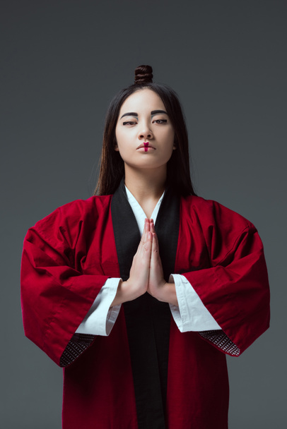 young asian woman in kimono looking at camera isolated on grey - Foto, afbeelding