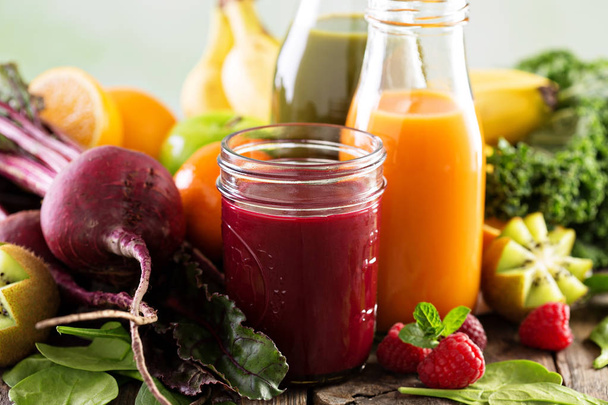 Fresh vegetable and fruit juices with beets, berries and greens - 写真・画像