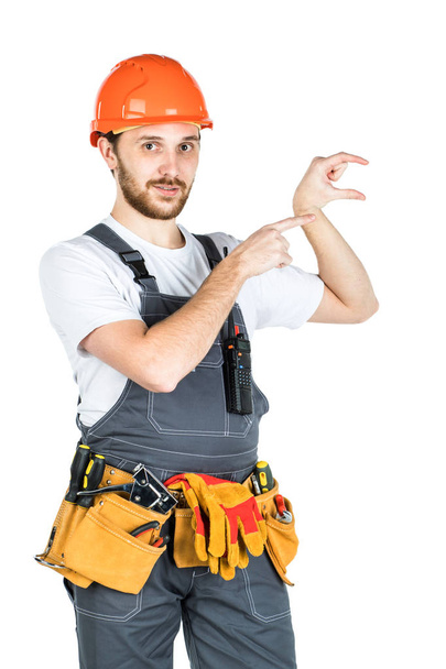 The man builder shows something. Isolated over white background. - Photo, Image