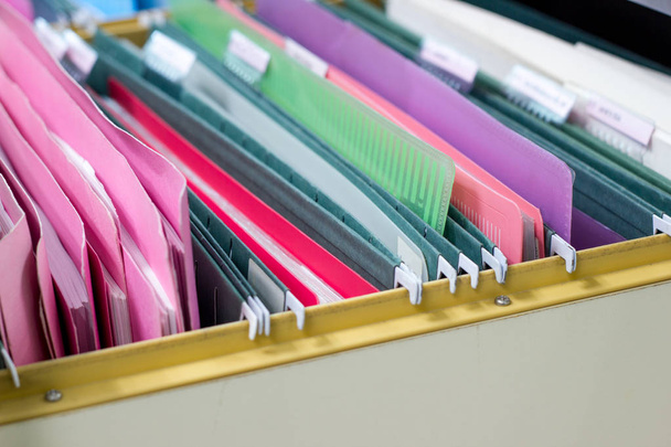 files document of hanging file folders in a drawer in a whole pile of full papers in the work office, business concept. - Photo, Image