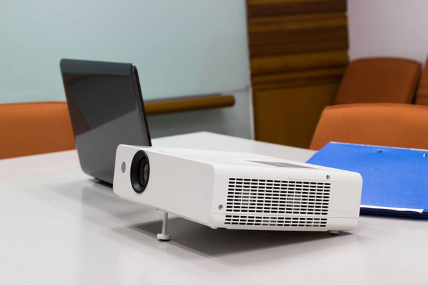 proyector conectado al ordenador portátil con carpeta de archivos sobre la mesa en una sala de reuniones, Business Concept
. - Foto, imagen