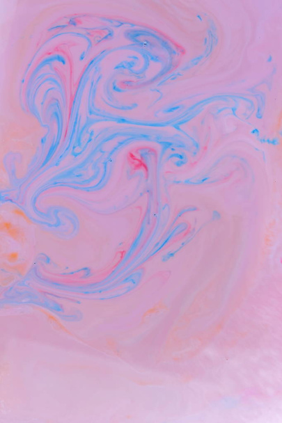 Abstract multicolored background with orange dyes on liquid, orange stains on milk, cosmic holographic pattern, minimalism, pop art texture for designer - Φωτογραφία, εικόνα