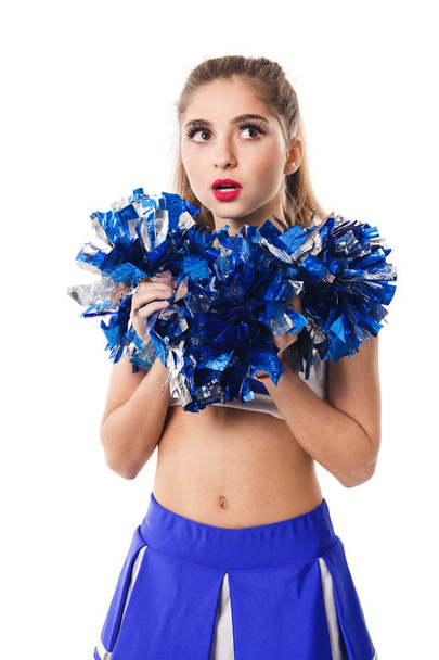 Young cheerleader in blue and white suit with pompoms on white background. - Fotó, kép