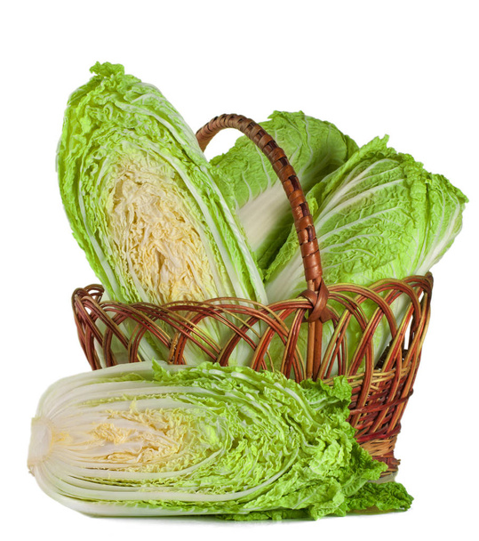 chinese cabbage and half in a wicker basket isolated on white background - Фото, изображение