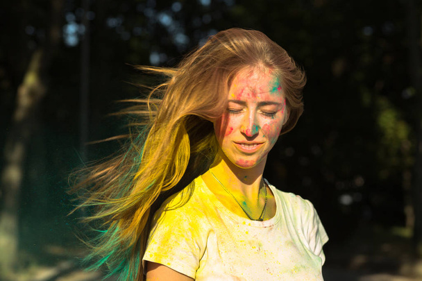 Glorious young woman with flying hair celebrating Holi festival - Foto, Imagem