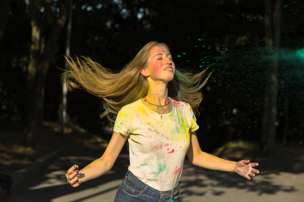 Cool young woman tossing up her hair on Holi festival - Photo, Image