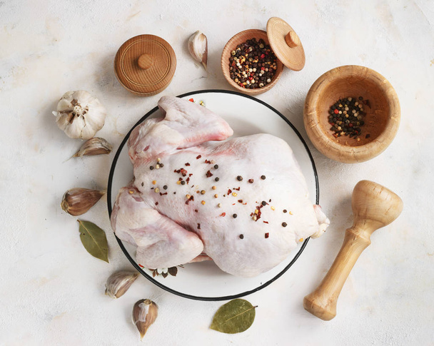 chicken with seasonings on a light background - 写真・画像