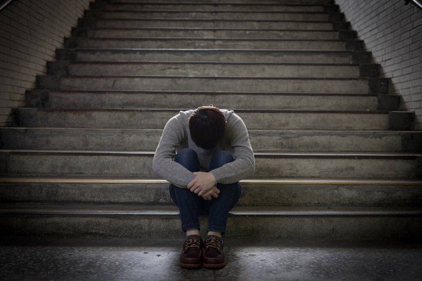depressed man feelinf upset and sitting in underground - Fotó, kép