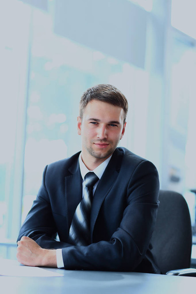 young businessman working in office, sitting at desk - Photo, image