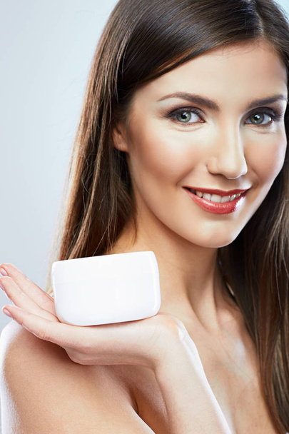 smiling attractive woman holding jar cream - Photo, image