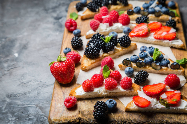 Selection of toasts with cheese peanut butter and berries - Fotografie, Obrázek