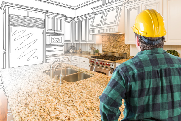 Male Contractor with Hard Hat Looking At Custom Kitchen Drawing Photo Combination On White. - Photo, Image
