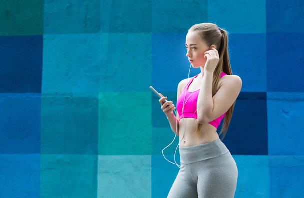 Woman choose music to listen during workout - Foto, Bild