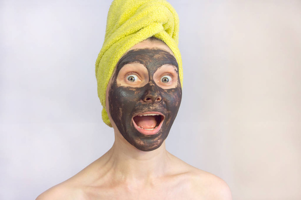 woman gets cosmetic mask on face. beautiful girl in facial mask. portrait. - Фото, зображення