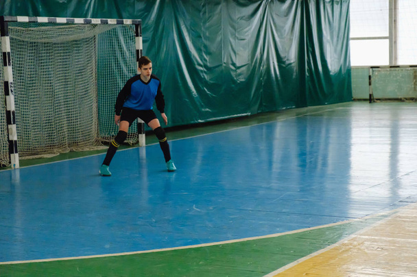 Goalkeeper catching a ball, mesh of the gate in mini football - Foto, Imagem