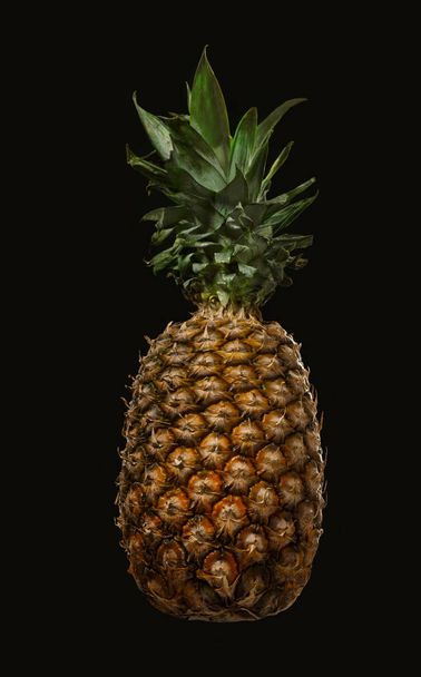 Pineapple isolated on black background. Ripe and juice pineapple - Foto, afbeelding