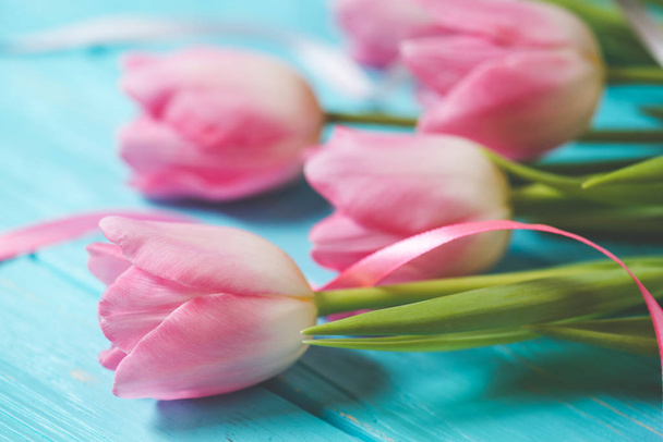 Wooden blue background and pink tulips - 写真・画像