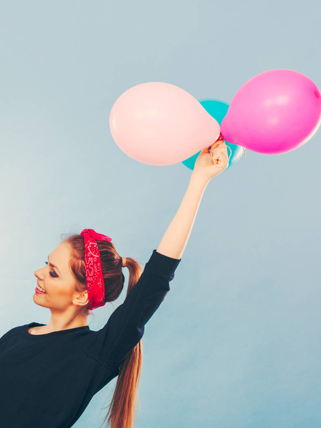 Lovely smiling girl holds colorful balloons. - Fotoğraf, Görsel