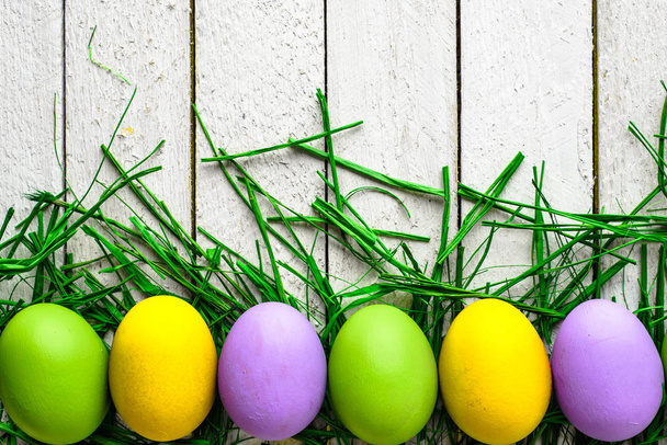 Happy easter eggs on wooden background, colorful eggs on white boards - Фото, зображення