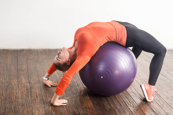 energy woman balancing and doing bridge pose on fitness ball  - Photo, Image